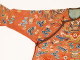 an orange jacket with a dragon design on it