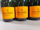 three bottles of wine are lined up on a table