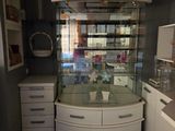 a glass display case in the middle of a kitchen