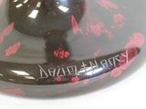 a black and red object on a white surface