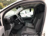 the interior of a car with the door open and the driver ' s seat down