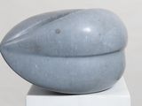 a sculpture of a pear sitting on top of a white pedestal