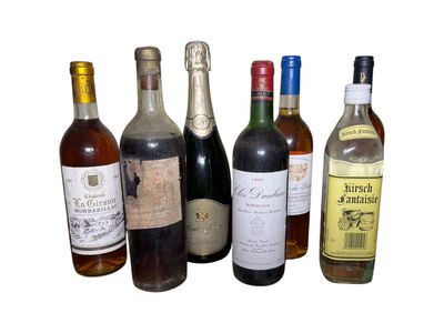 several bottles of wine are lined up on a white surface