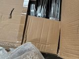 a lot of items in a cardboard box on the floor