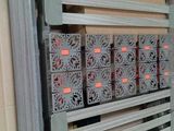 a metal rack with many different types of boxes in it