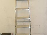 a ladder that is leaning against a wall in a room