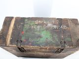 an old wooden box with a sign on it