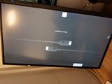 a flat screen tv sitting on top of a table