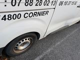 a white van that is parked on the side of the road