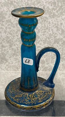 a blue vase with a gold rim on a stand