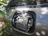 a silver car with a license plate on the door
