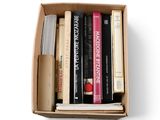a box of books on a white background with a pen