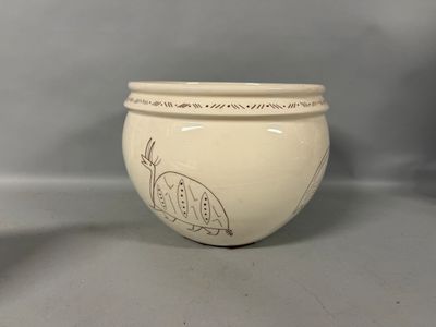 a white bowl with a drawing on it on a table