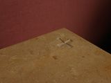 a small cross on the table in the corner of the room