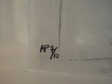 graffiti on the wall of a bathroom with a toilet and a sink