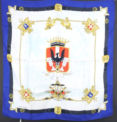 a close up of a blue and white scarf with a coat of arms on it