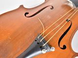 a close up of a violin with strings attached to it