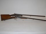 an old gun with two guns on a white surface