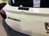 a close up of a white car with a sticker on it