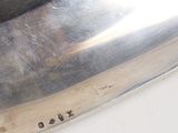 a close up of a silver plate on a table