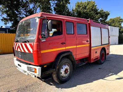 a red fire truck that is parked in a lot