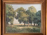 une peinture à l'huile d'un paysage avec des arbres dans un cadre doré
