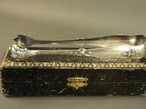 a silver spoon and fork in a box on a table