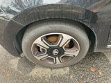 a close up of a car ' s tire on the street