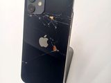 an image of a broken iphone sitting on top of a stand