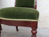 a green chair that is sitting on the floor