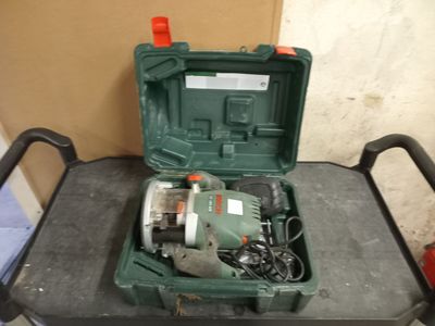 a green tool box sitting on top of a black cart