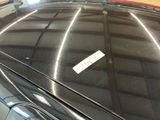 a sticker on the hood of a car in a garage