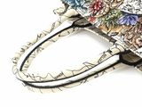 a small purse with a floral design on it
