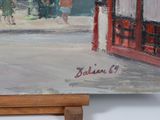 a painting on a easel with a painting of a street scene