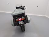 a motorcycle parked in a room with a white wall