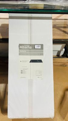 a white box on a glass table with a remote on it