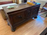 a wooden chest sitting on top of a hard wood floor