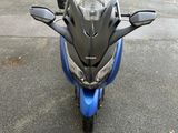 a motorcycle that is parked on the street in the parking lot