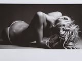 black and white photograph of a woman laying on the floor