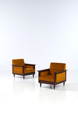 pair of mid century lounge chairs in the style of person