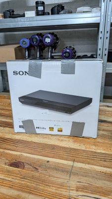a box on the table with a remote control on top of it