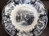 a black and white plate with a picture of people on it