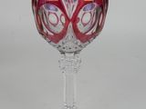 a wine glass that has a purple and red design on it