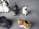 several figurines of cats and dogs are sitting on a table