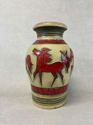 a vase with a horse design on it on a white background