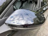 a reflection of the sky in the side view mirror of a car