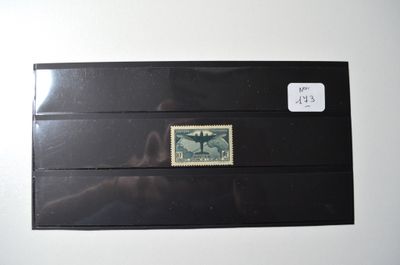 a black envelope with a stamp on it on a white surface