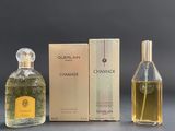 two bottles of perfume sitting next to each other on a table