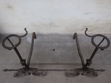 two iron tools that are sitting on the ground
