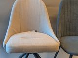 two chairs sitting next to each other on a white surface